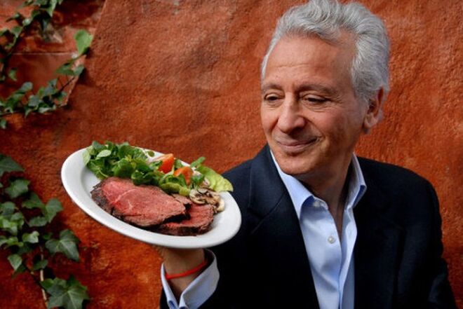 Pierre Ducan with a plate of meat and vegetables